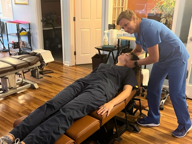 Rosemarie massaging a patient's scalp